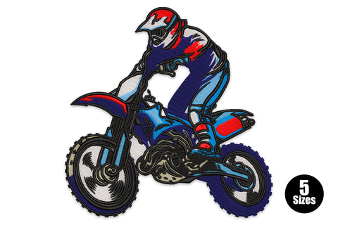 Motocross dirt bike rider embroidery, navy suit with red helmet, leaning forward on blue dirt bike with chunky black tyres
