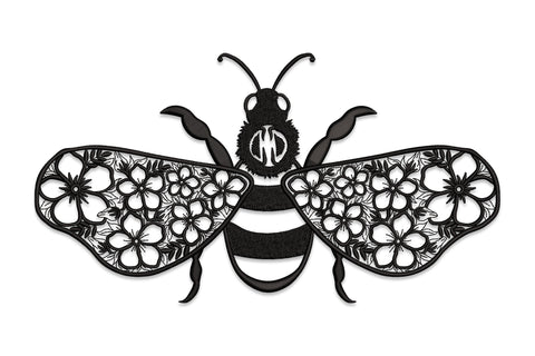 Floral bee embroidery: solid satin-striped body, wide wings packed with outline flowers in a lace cutwork style.