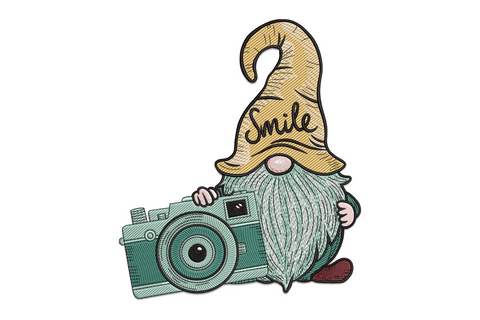 Gnome photographer embroidery design showing a chubby gnome crouching behind a teal vintage camera, wearing a tall golden hat with Smile written in cursive and a fluffy grey beard.
